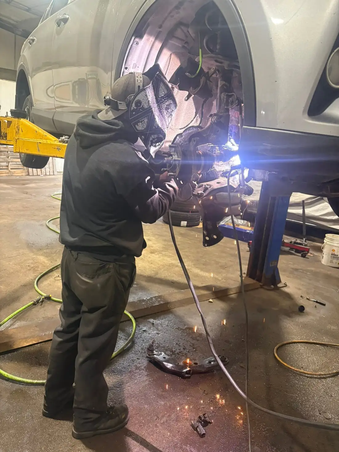 AutoNorth technician performing a suspension repair in the North Bay shop