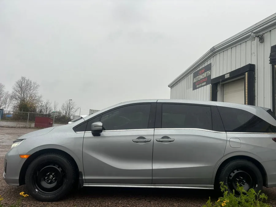 Silver minivan on black steel rims parked outside AutoNorth Auto Repair on Cholette St in North Bay